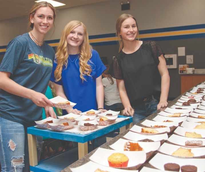 HAPPY TO HELP: Lipan juniors (from left) Madi H, Grace H and Dylan S enjoyed teaming up with fellow student council and National Honor Society members to serve the huge crowd of first responders.